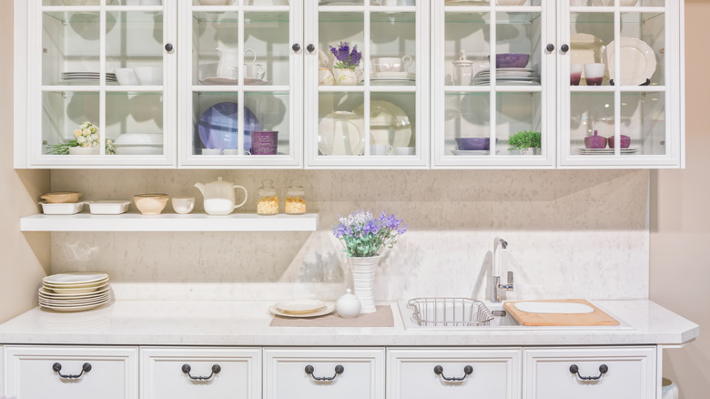 White kitchen with glass door cabinets