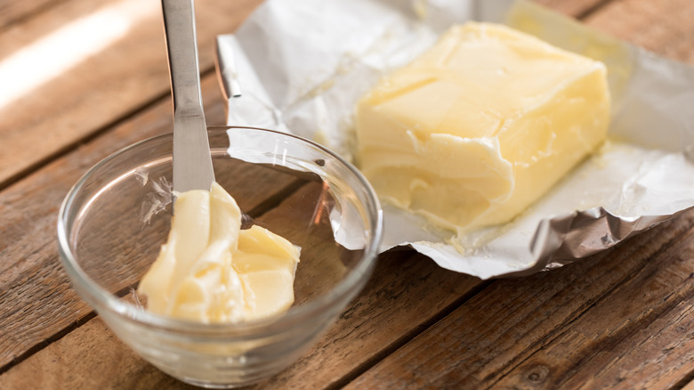 Soft butter in a wrapper and in a bowl