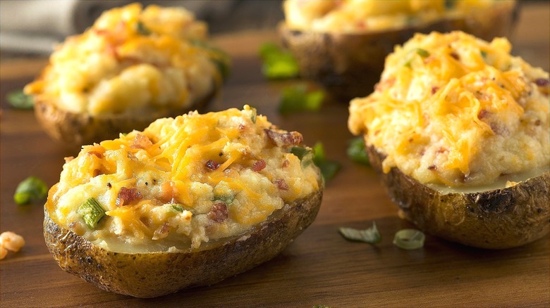 Closeup of twice-baked potatoes stuffed with cheddar cheese, bacon, and diced green onions