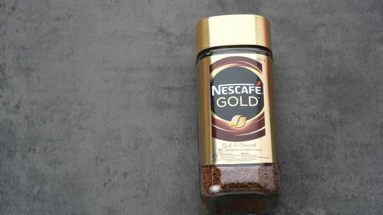 a jar of Nescafe gold instant coffee on a table