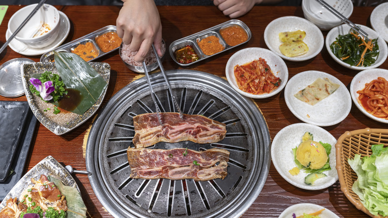 Korean BBQ with banchan and grill