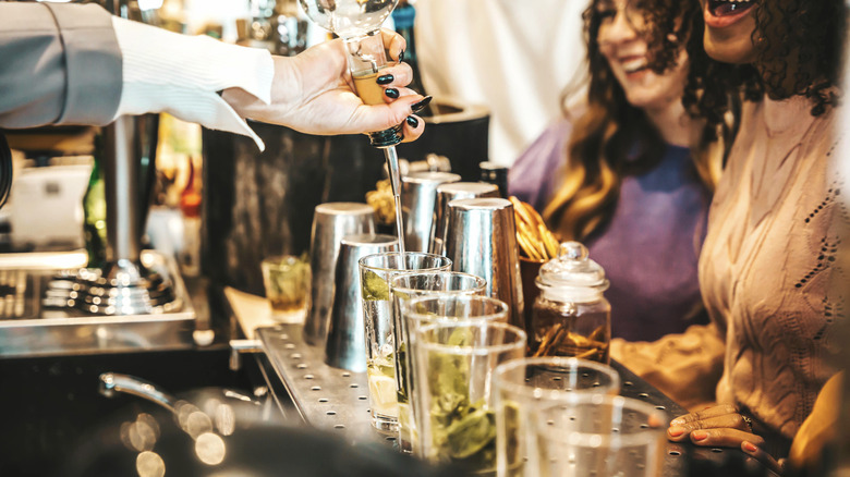 Bartender making drinks for customers