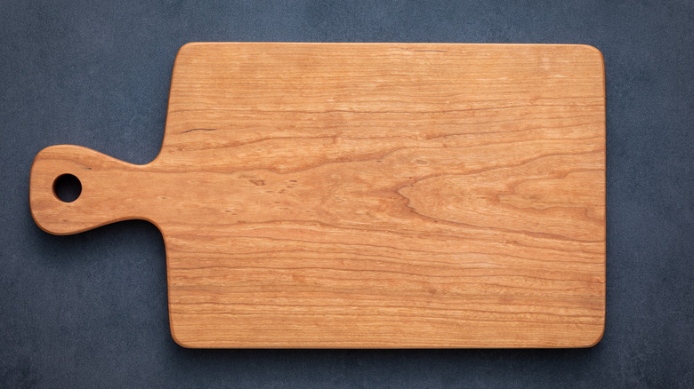 Wooden cutting board on slate surface