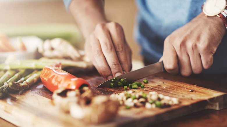 Person chopping vegetables on a cutting board