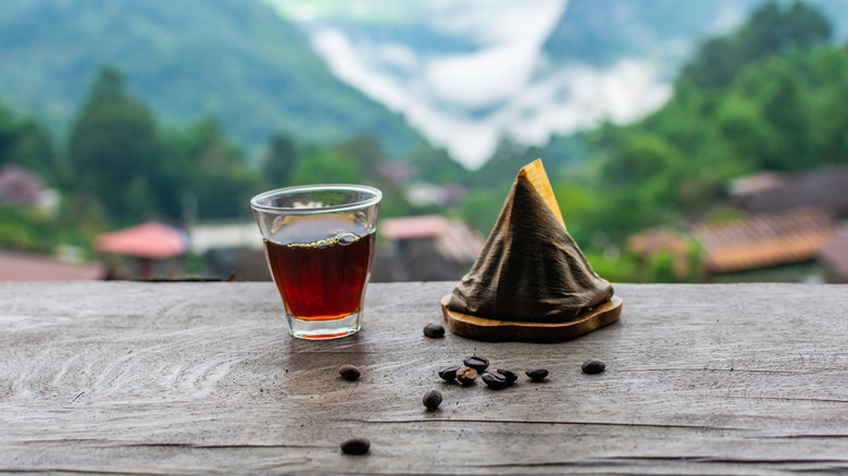 Coffee and coffee beans overlooking a mountain range