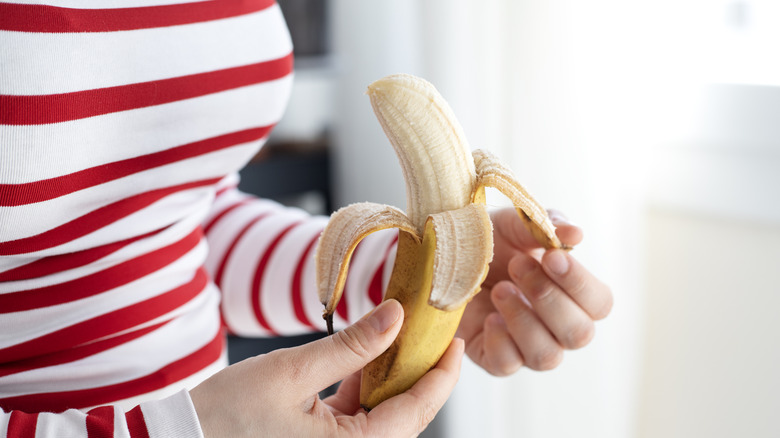 person peeling banana