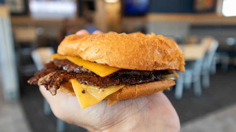 A hand holding a Culver's burger