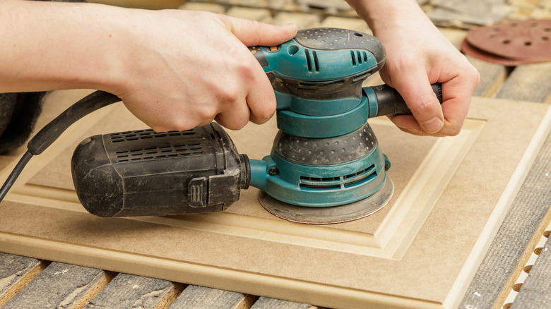 Sanding a cabinet