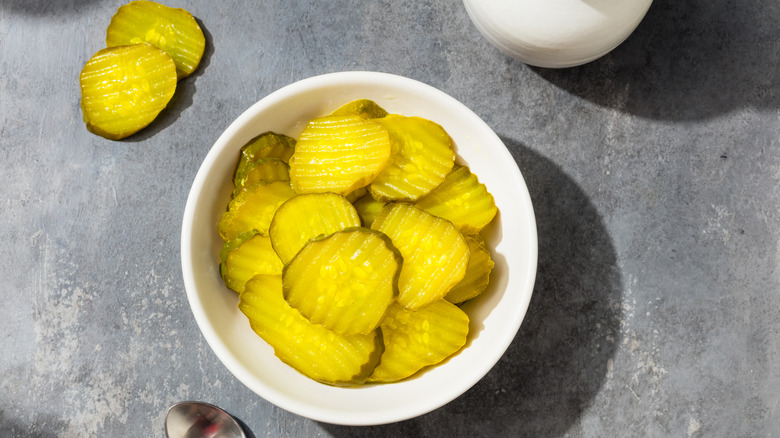 Bowl of sliced dill pickles