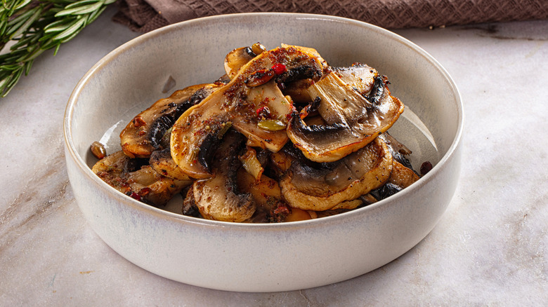 Close up of sliced sauteed mushrooms in a bowl