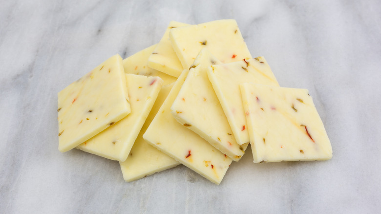 Slices of pepper jack cheese on a marble surface