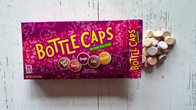 Bottle caps candy box on white surface