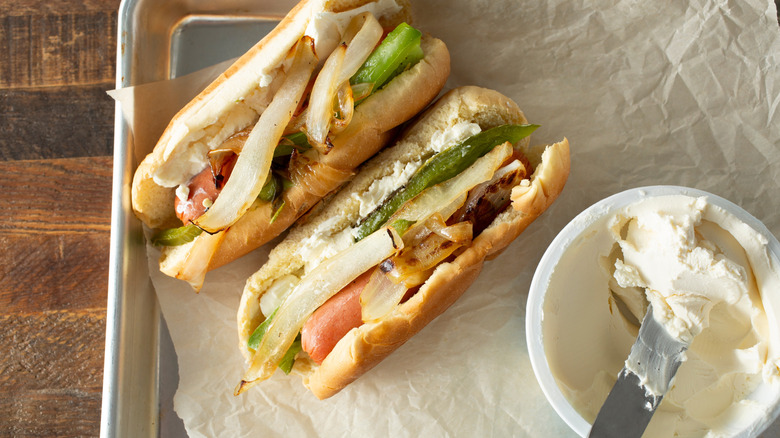 Person making Seattle dog with cream cheese