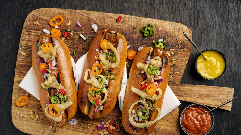 Colorful toppings on several hot dogs