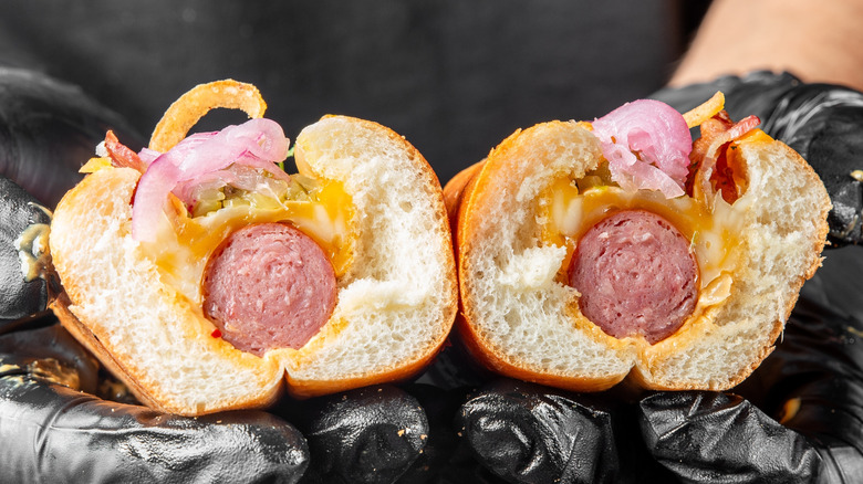 Hot dog topped with red onions on top