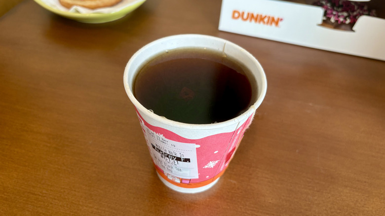 A Bold Breakfast Black Tea from Dunkin' with a Dunkin' box and donut in the background