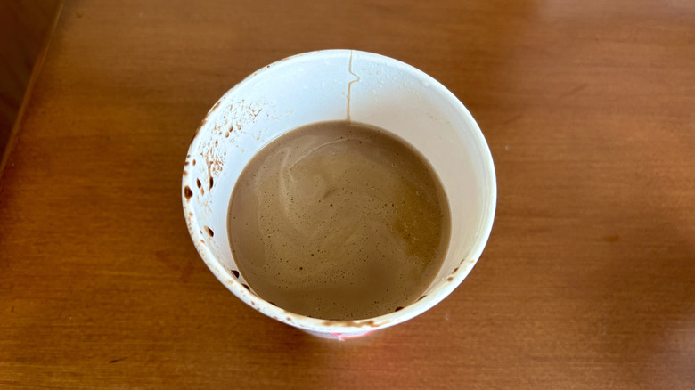 A Cocoa Mocha Signature Latte from Dunkin' on a wood surface