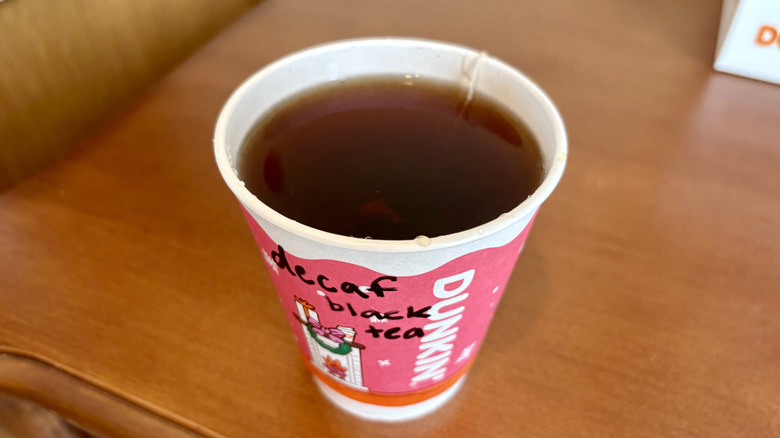 A Decaf Breakfast Black Tea from Dunkin' on a wood surface