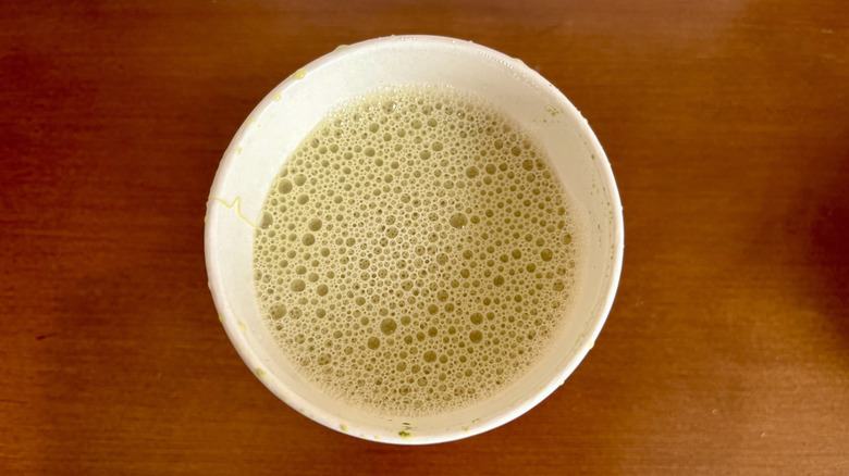 A matcha latte from Dunkin' on a wood surface