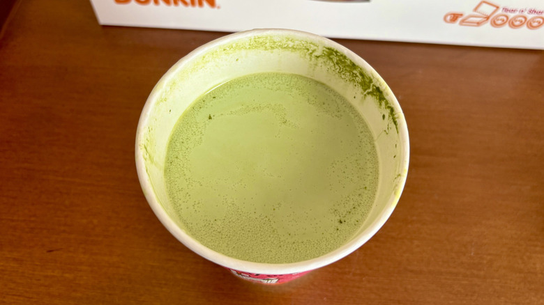 A Protein Matcha Latte from Dunkin' with a Dunkin' box in the background