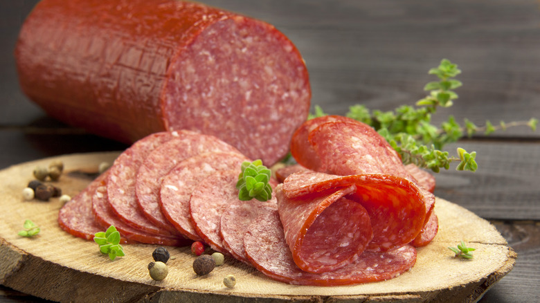 salami sliced on a wooden cutting board