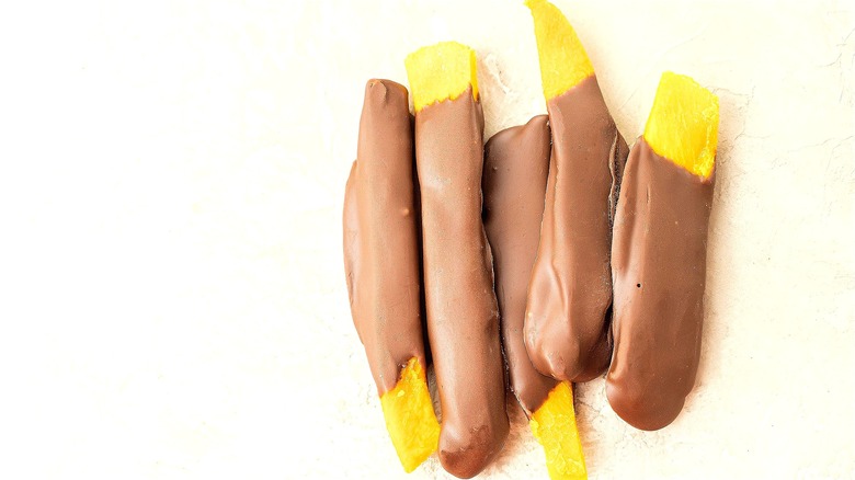 Dried mango strips dipped in milk chocolate