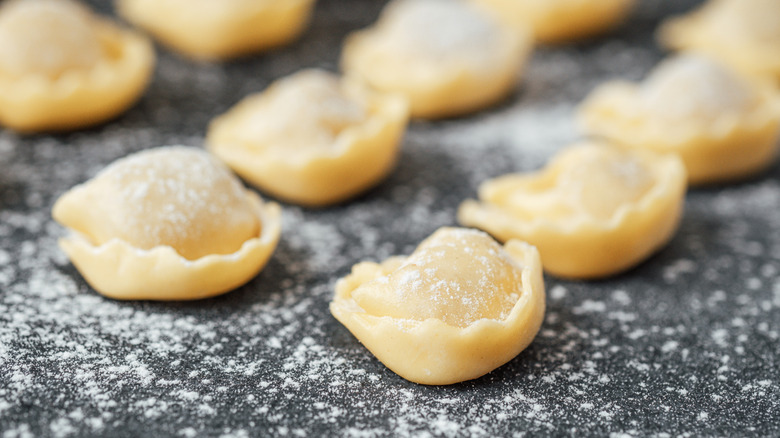 A close up of fresh, uncooked cappelletti pasta