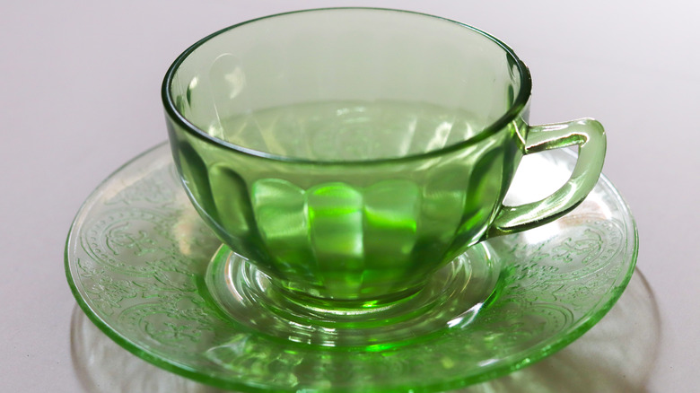 Bright green glass teacup and saucer.