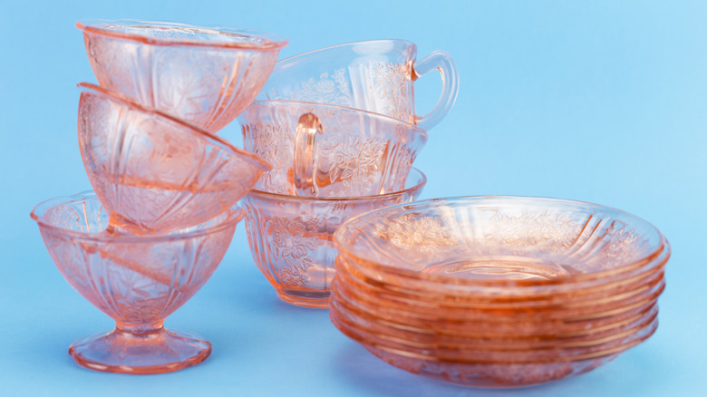 Stacks of pink glass teacups.