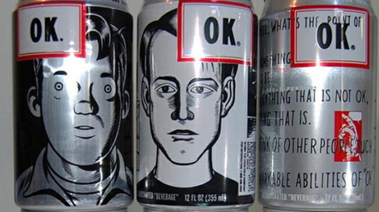 A close up on three cans of OK Cola