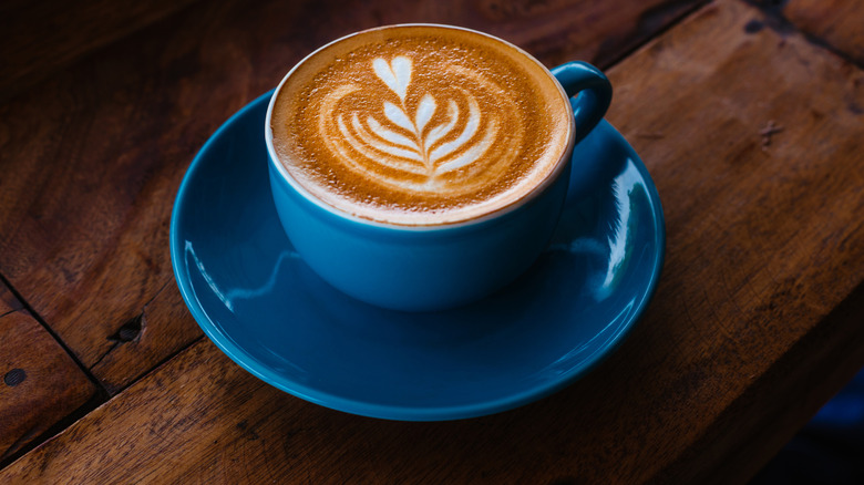 cappuccino in a blue mug with heart-shaped foam