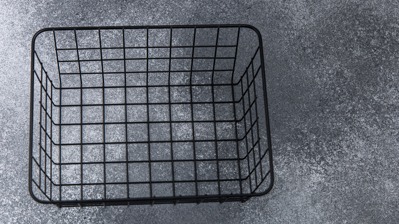 Black wire basket on gray countertop.