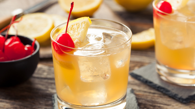 whiskey sour with cherry garnishing.