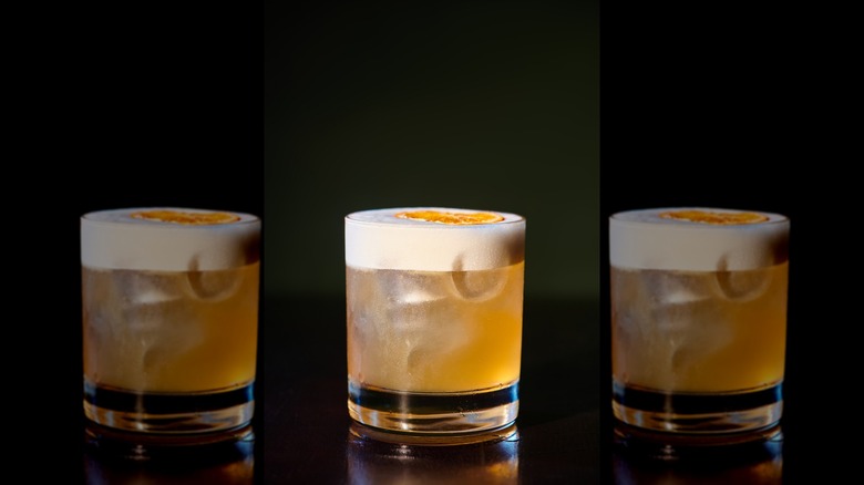 Glass of frothy whiskey sour.