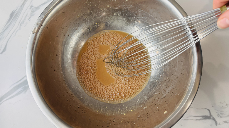 Whisking vinaigrette in a bowl