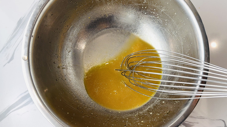 Whisking red wine vinaigrette in a bowl
