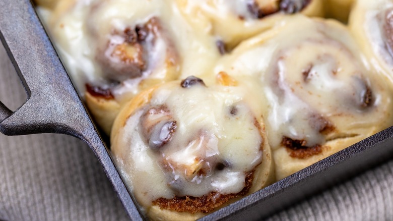 Frosted cinnamon rolls in a baking dish