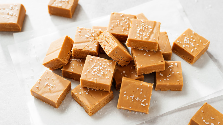 Salted peanut butter fudge sitting on wax paper