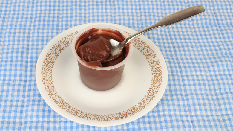 Plastic cup of chocolate pudding with spoon