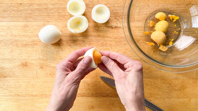 Removing yolks from hard boiled eggs