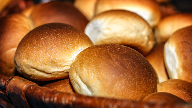 Fresh hamburger buns in a basket.