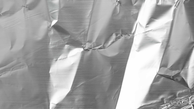 A sheet of shiny aluminum foil slightly crumpled