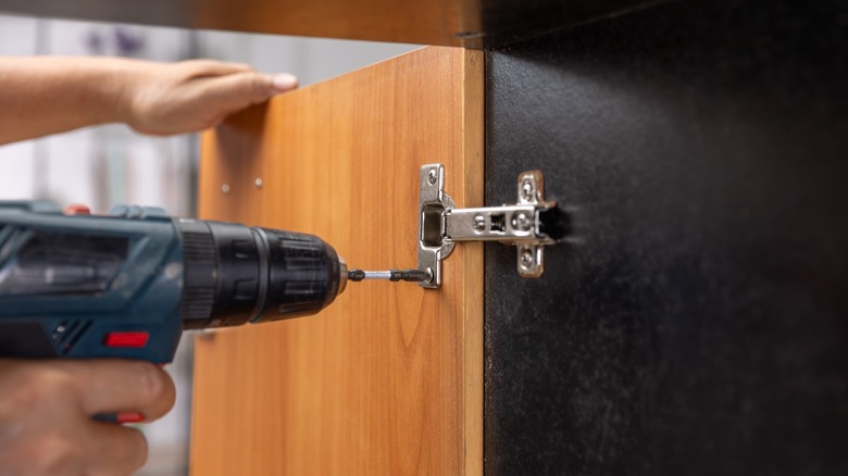 cabinet hinges and a screw gun