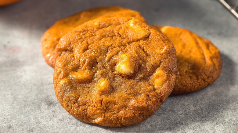 Three pumpkin cookies with white chocolate chips