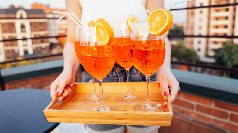 person holding tray of cocktails