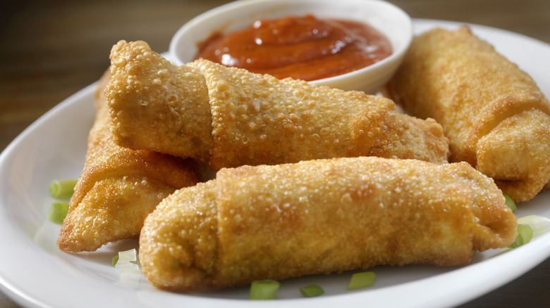 Plated egg rolls and sauce