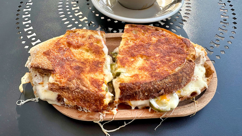 A toasted cheesy sandwich on a plate