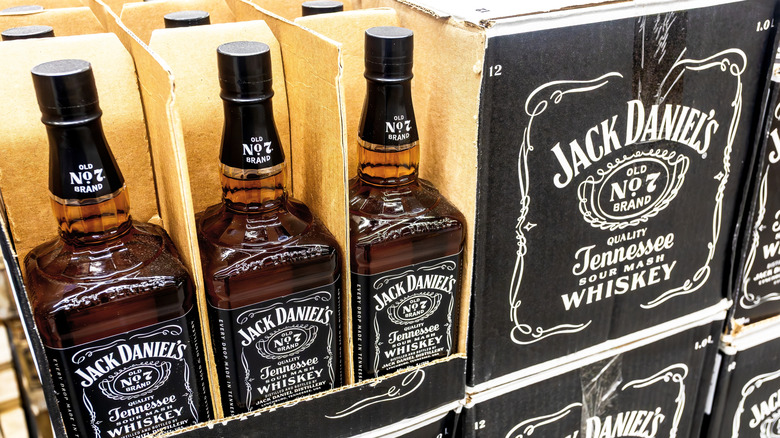 Bottles and cases of Jack Daniel's appear on store shelves.