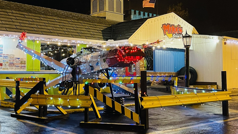 exterior of Mike's Place with prop plane and signage