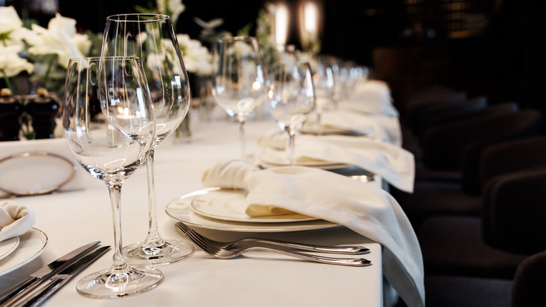 beautifully set table with ivory and gold dinnerware